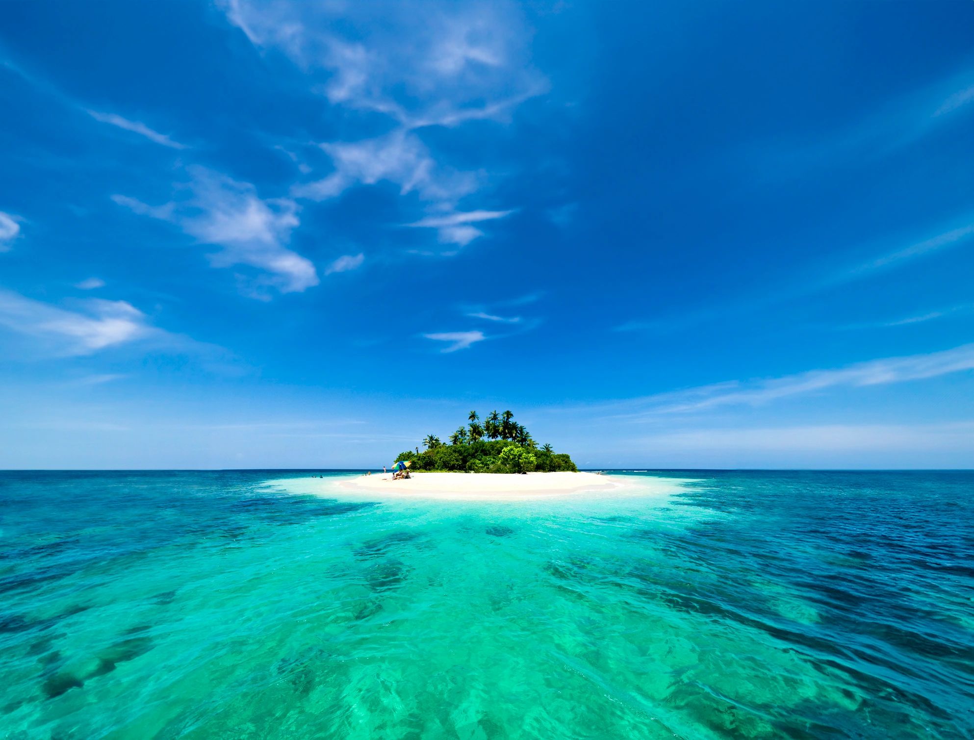 Tropical white sand remote cay with coconut trees in the Caribbean